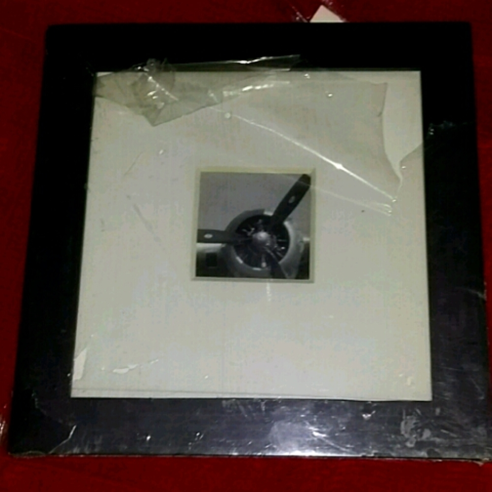 A brown picture frame of airplane